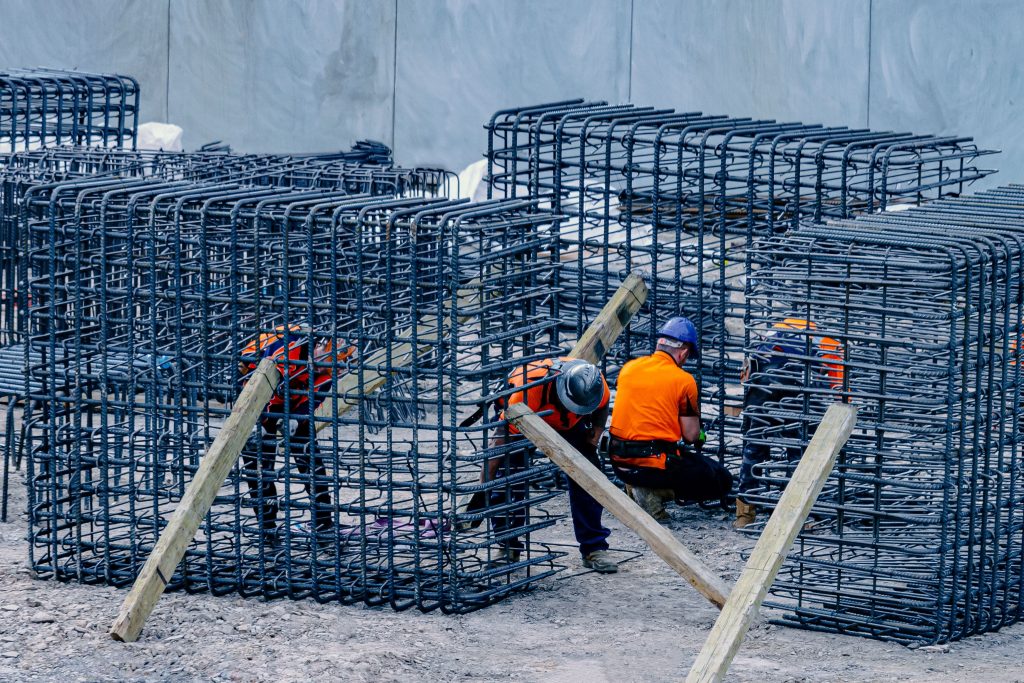 pexels-photo-7961889-7961889 Construction workers assembling steel frames at a site, ensuring structural integrity.
